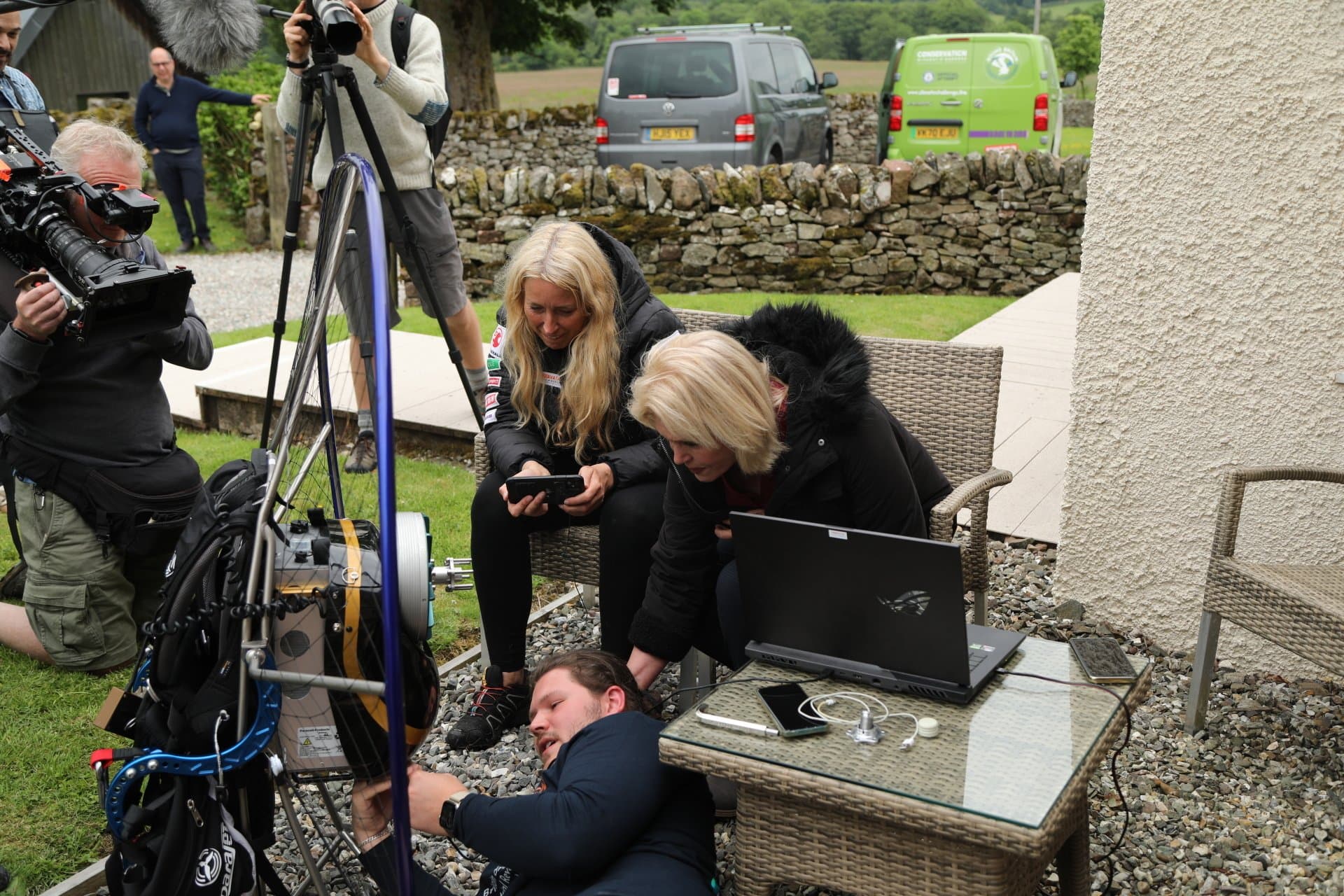 On location during a conservation film shoot: Joanna Lumley with crew reviewing footage on a laptop beside camera and sound equipment.